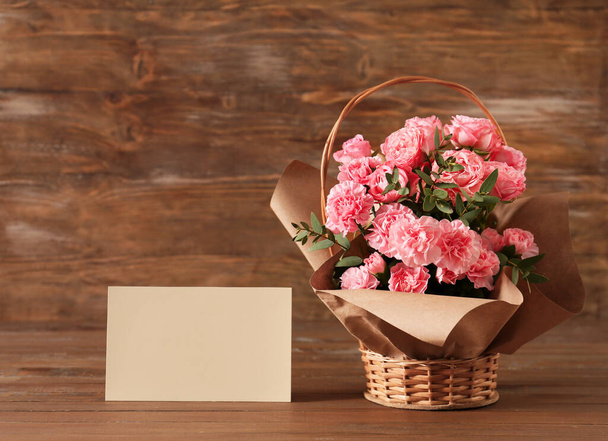 Basket with flowers for Mother's Day on wooden background - Fotografie, Obrázek