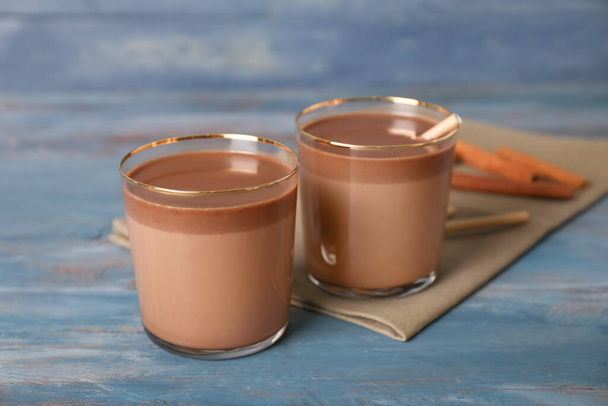 Glasses of hot chocolate on wooden background - Zdjęcie, obraz