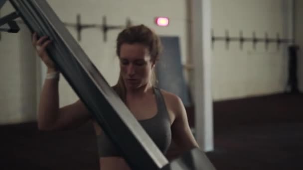 Female Athlete Moving Rowing Machine - Кадры, видео