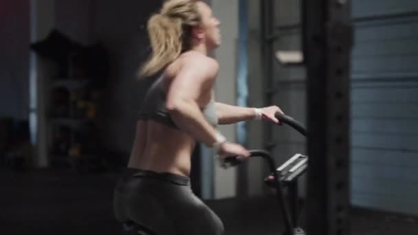 Female Athlete In Gray Cycling On Cross Training Bike - Filmati, video
