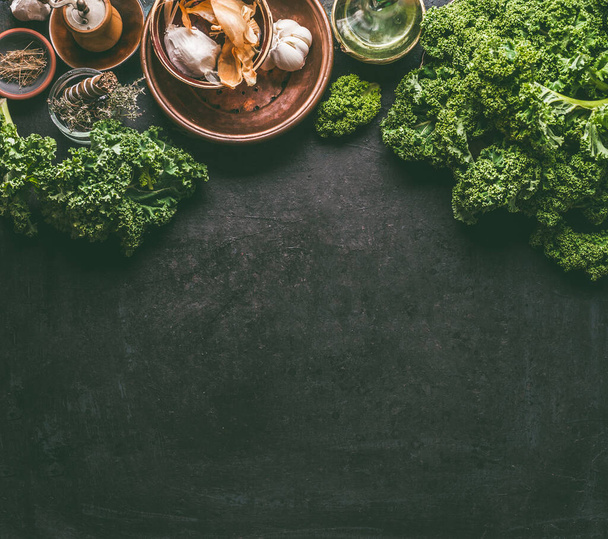 Green kale food background on dark rustic kitchen table. Healthy detox vegetables . Clean eating and dieting concept. Top view with copy space. - Foto, immagini