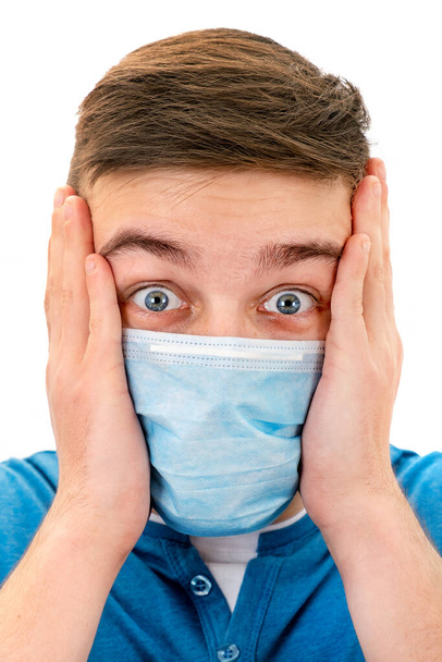 Шокированный молодой человек в маске гриппа, изолированной на белом фоне крупным планом
 - Фото, изображение