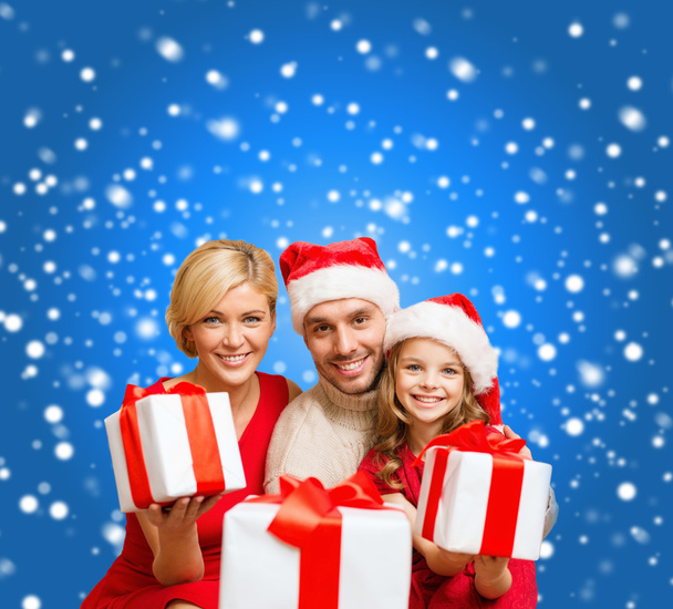 Smiling family giving many gift boxes - Photo, image