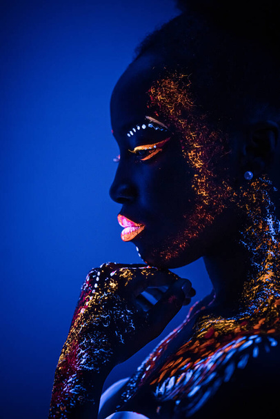 Portrait of beautiful african fashion model in neon UF light - Photo, image