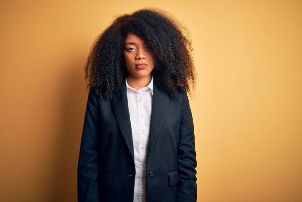 Young beautiful african american business woman with afro hair wearing elegant jacket depressed and worry for distress, crying angry and afraid. Sad expression. - Фото, изображение