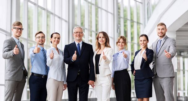 business people showing thumbs up at office - Фото, зображення