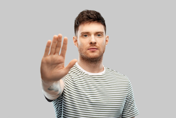 serious young man showing stop gesture - Fotografie, Obrázek