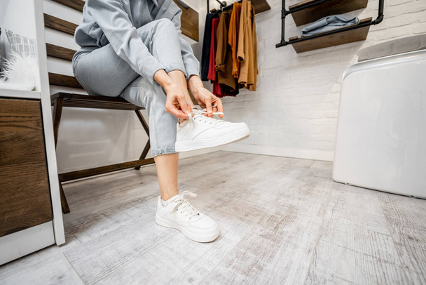 Woman wearing white sneakers indoors - Φωτογραφία, εικόνα