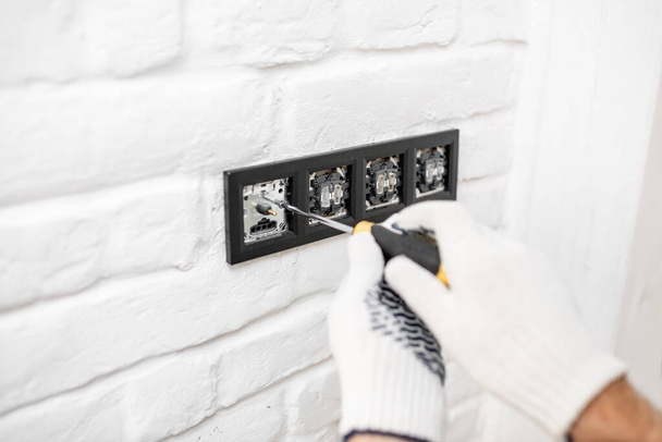 Electrician installing sockets and switches - Φωτογραφία, εικόνα