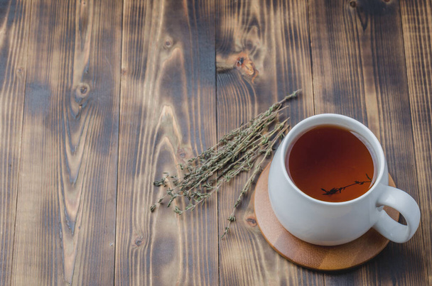 Thyme herbal tea on a wooden table, top view, space for a text - Foto, Imagem