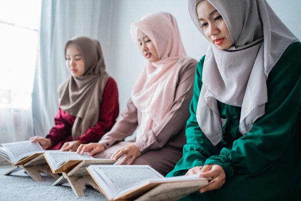 three asian moslem woman read and learn the holy book of the Al-Quran together - Photo, image