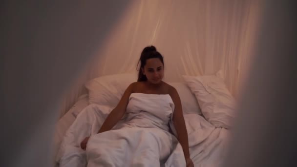 Beautiful Brunette Slowly Waking up in the Morning, Stretches and Gets Up from the Bed with canopy. Happy Young Girl Greets New Day - Footage, Video