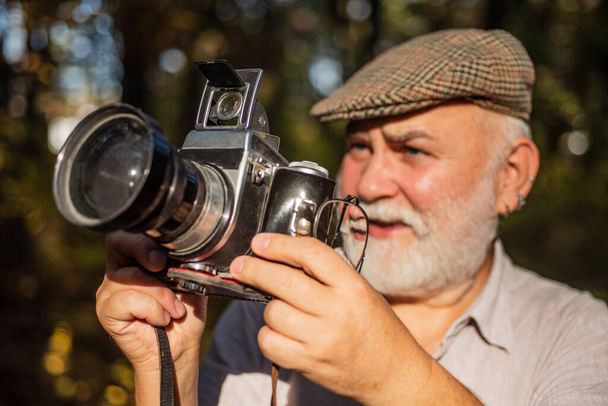 Pension hobby. Experienced photographer. Vintage camera. He likes birdwatching. Old man shoot nature. Professional photographer. Make perfect frame. Old photographer filming. Manual settings - Foto, imagen