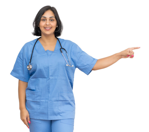 Latin american mature nurse poiting sideways isolated white background for cut out - Foto, immagini