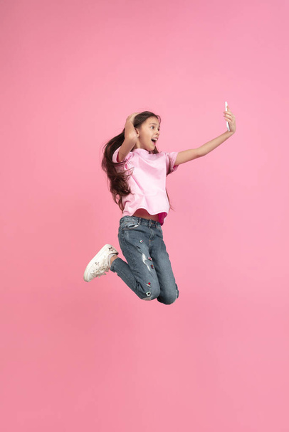 Caucasian little girl portrait isolated on pink studio background, emotions concept - Zdjęcie, obraz