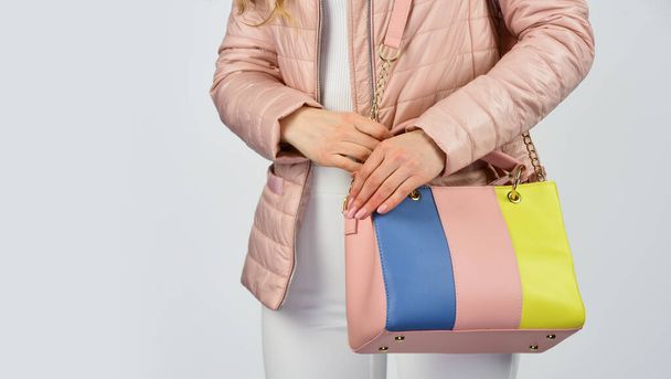 too casual. sexy and confident blond carry shoulder bag. handbag fashion and beauty. tote or shopper bag for any occasion. woman use leather clutch. girl wear puffer jacket. copy space - Foto, immagini
