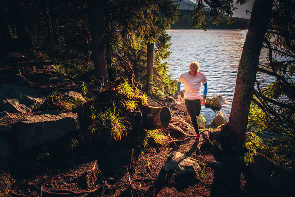 Morning free run in trail by mountains and lake, Strbske pleso, Slovakia - Foto, immagini