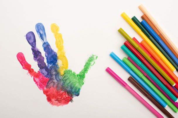 top view of colorful handprint and flat pens on white for World Autism Awareness Day - Photo, Image