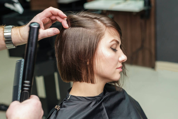 Professional hairdresser begins to do hairdo for girl - Photo, Image