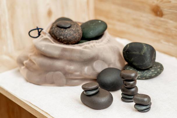 Set of stacks hot massage stones on towel in spa. - Photo, Image