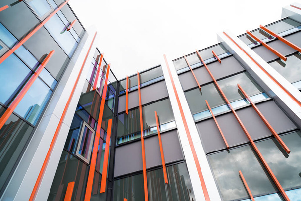 exterior of a modern office building with some orange accents - Foto, Imagen