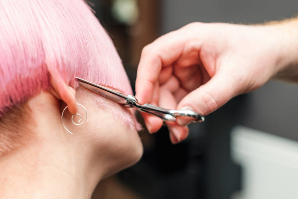 Haircut of pink hair of woman close up. - Photo, Image