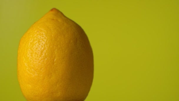 Yellow lemon rotation 360 degrees. Yellow background - Felvétel, videó