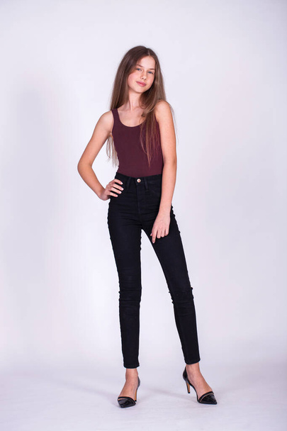Full body portrait of a young beautiful blonde model in black jeans, isolated on white background - Foto, immagini