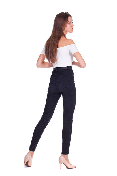 Full body portrait of a young beautiful brunette model in jeans, isolated on white background - Photo, image