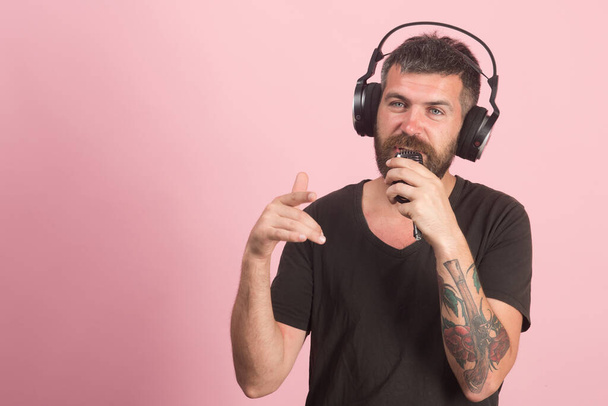 Dj with beard wears headphones. Singer with beard - Photo, Image