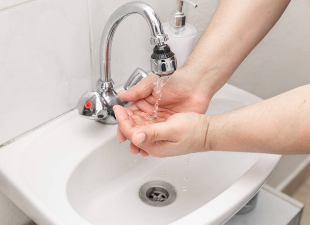 Man washes his hands with soap - Fotó, kép
