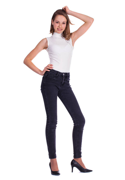 Full body portrait of a young beautiful blonde model in black jeans, isolated on white background - Foto, imagen