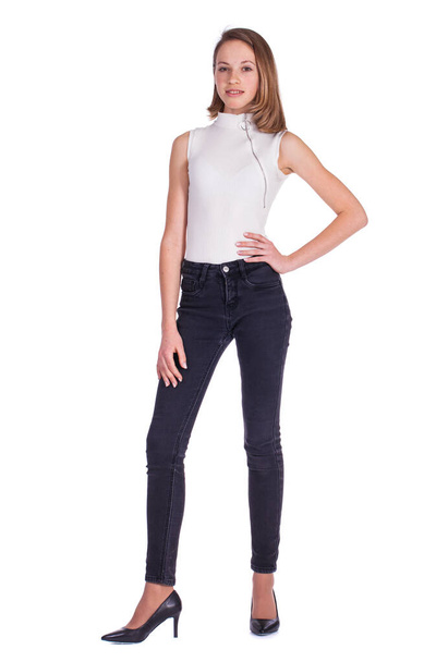 Full body portrait of a young beautiful blonde model in black jeans, isolated on white background - Фото, зображення