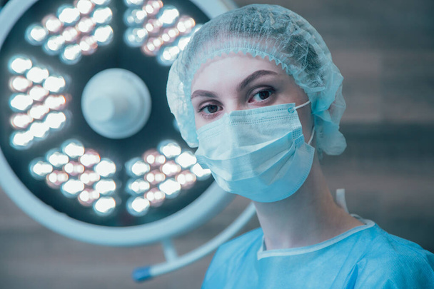 Calm surgeon in medical mask and sterile uniform in the operating theatre - Foto, Imagem