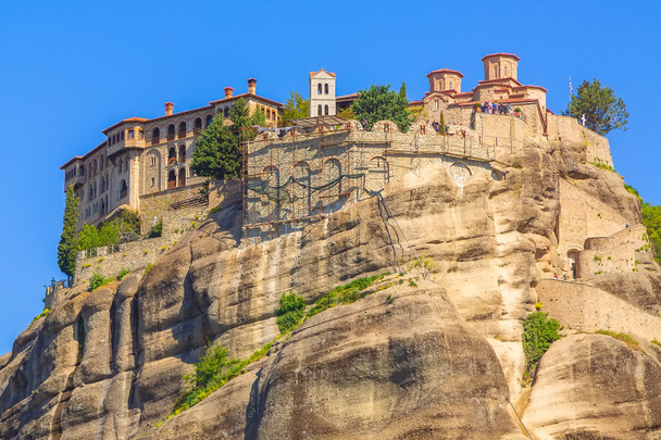 Close-up view of the Orthodox Varlaam Monastery in Meteora, Greece on high mountain rock and blue sky - Fotó, kép