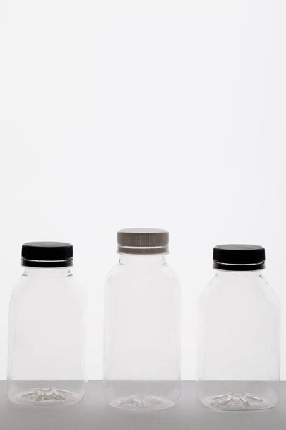 clean, empty plastic bottles on white background - Foto, imagen