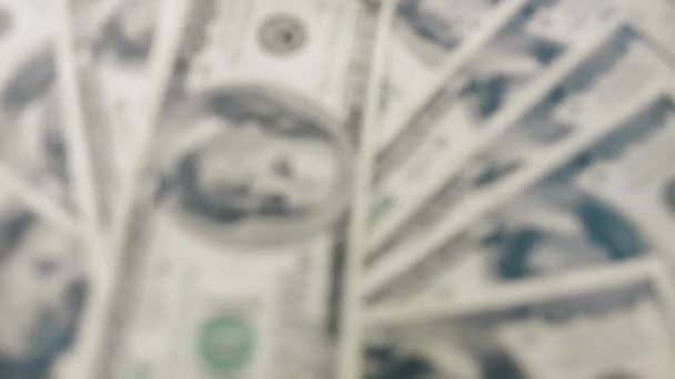Spinning unfocused 100 dollars USA banknotes. Wealth, crisis, investment, success or business concept. - Footage, Video