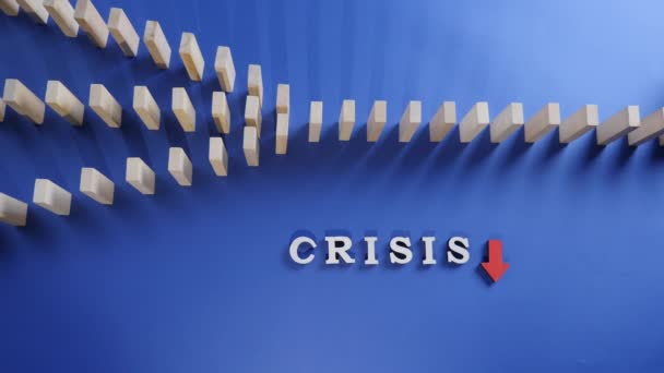 赤い矢印と青の背景にドミノ効果と木製のブロックを落下危機的な言葉。金融の停滞、不況、危機、事業崩壊、経済崩壊の概念. - 映像、動画