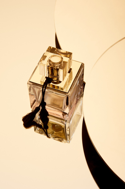 High angle view of perfume bottle on round mirror surface - Foto, imagen