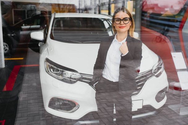 business woman buys a car at a car dealership. Concept of happy business people - Fotó, kép