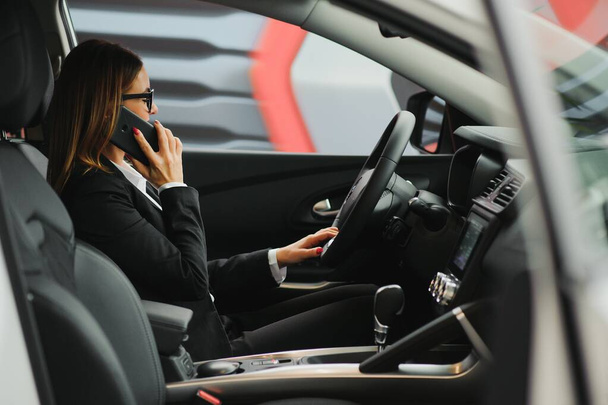 Young business woman driving in her car to work. Successful business concept. business woman driving - Foto, Imagen