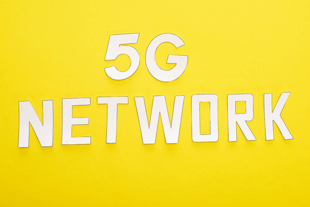 top view of white 5g network lettering on yellow background - Φωτογραφία, εικόνα