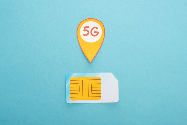 top view of sim card and 5g lettering on blue background - Photo, Image