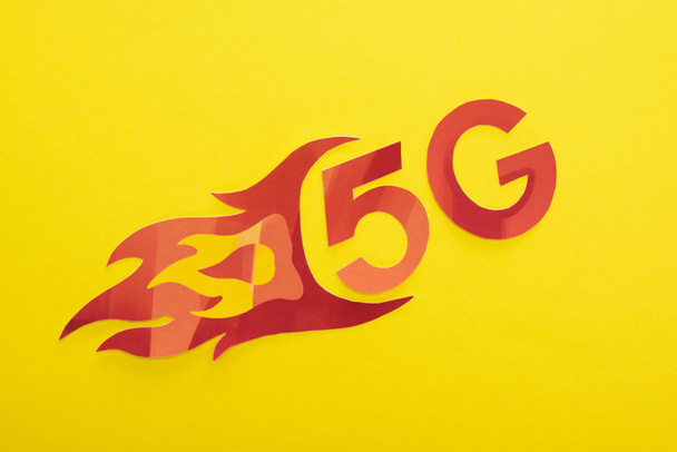 top view of red 5g with flame lettering on yellow background - Photo, Image
