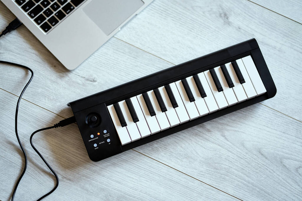 keyboard musical instrument on a white floor - Fotó, kép
