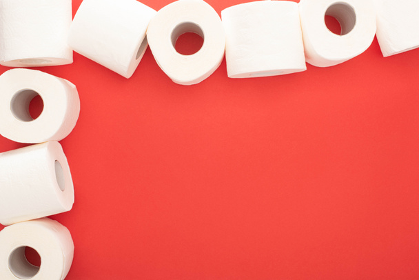 top view of white toilet paper rolls on red background with copy space - Φωτογραφία, εικόνα