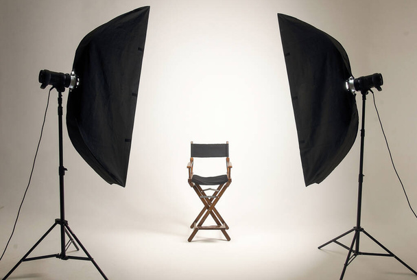 Empty photo studio with lighting equipment. Space for text. Vacant chair. The concept of selection and casting. Screensaver for your desktop. - Foto, Imagem