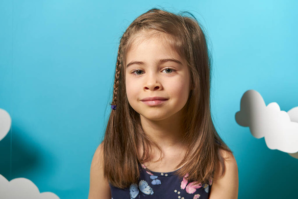 little girl in dress on blue background - Valokuva, kuva