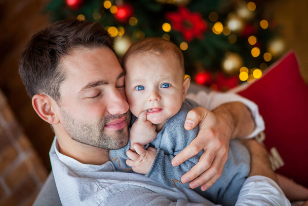 dad hugs newborn son christmas lights - Foto, Bild