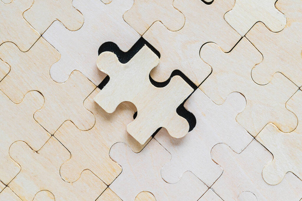 Close up Shot of wooden jigsaw puzzle pieces on black background, Business concept - Fotografie, Obrázek